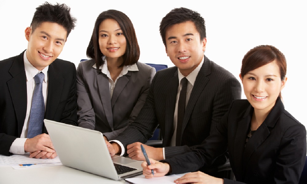 Studio Shot Of Chinese Businesspeople Having Meeting